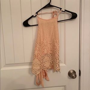 Peach colored lace pattern crop top with open back